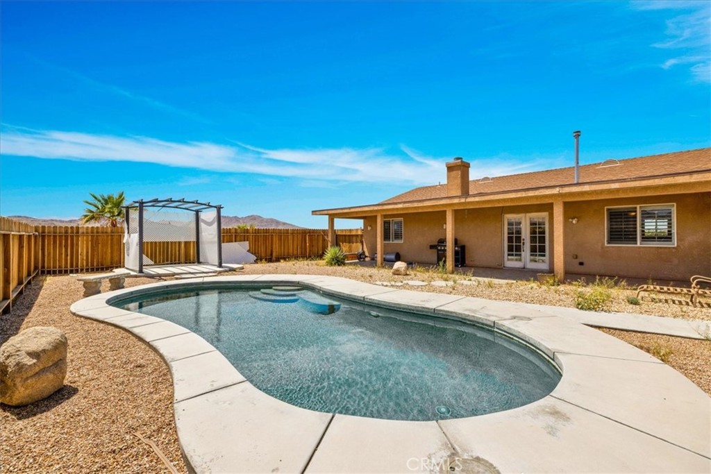 63357 Uranium Road Joshua Tree, CA 92252 - Photo 32 of 54 a view of a house with swimming pool