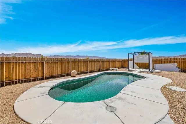 a backyard of a house with barbeque oven table and chairs