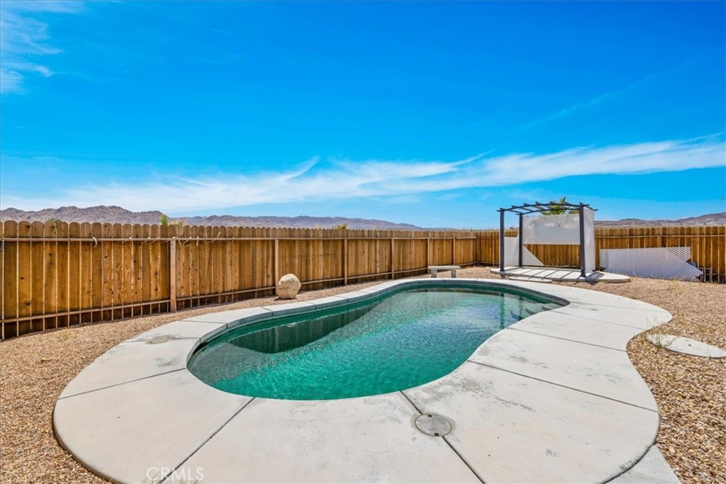 63357 Uranium Road Joshua Tree, CA 92252 - Photo 33 of 54 a view of a swimming pool with a chairs