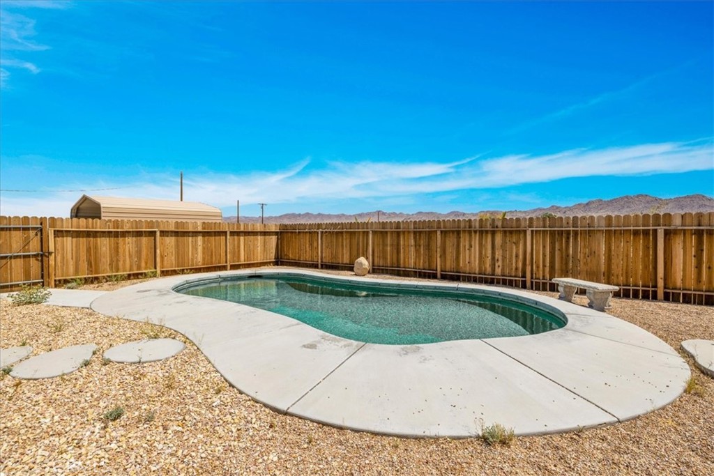 63357 Uranium Road Joshua Tree, CA 92252 - Photo 34 of 54 a view of a swimming pool with a backyard
