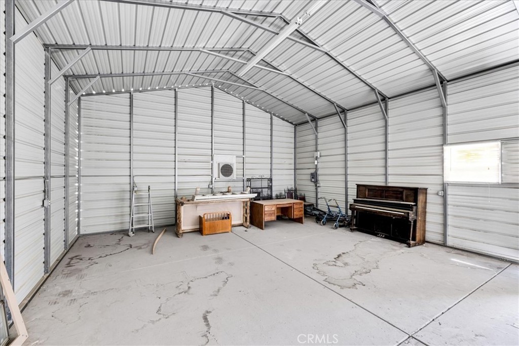 63357 Uranium Road Joshua Tree, CA 92252 - Photo 36 of 54 a backyard of a house with barbeque oven table and chairs
