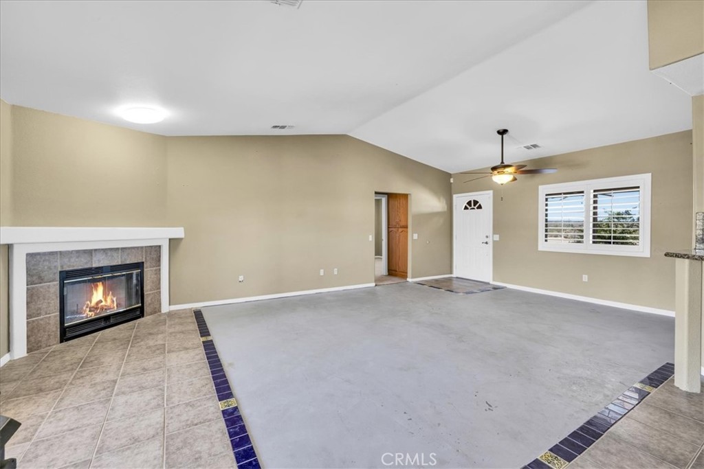 63357 Uranium Road Joshua Tree, CA 92252 - Photo 4 of 54 a view of an empty room with a fireplace and a window