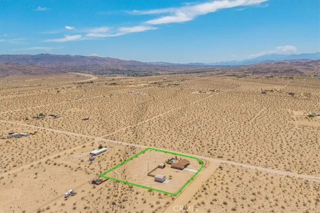 an aerial view of a house with a swimming pool