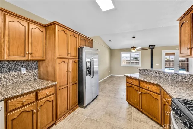 a open kitchen with cabinets and flat screen tv