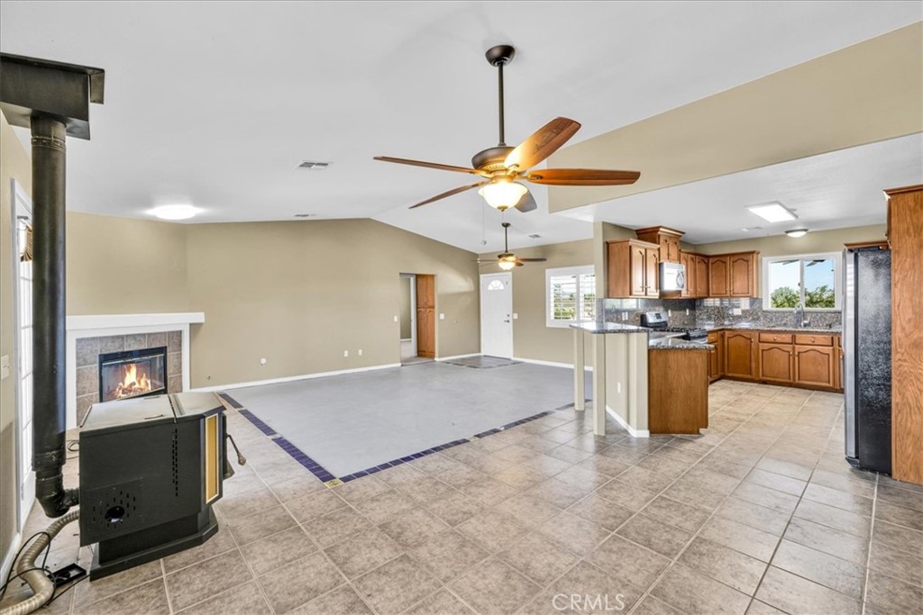 63357 Uranium Road Joshua Tree, CA 92252 - Photo 10 of 54 a open kitchen with cabinets and flat screen tv