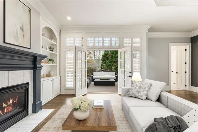 a view of staircase with lots of frames on wall and a window