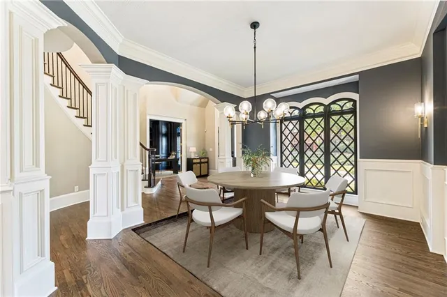 a view of an empty room with wooden floor fireplace and a window