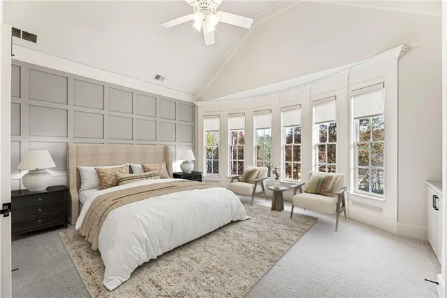 a kitchen with stainless steel appliances kitchen island a white table and chairs