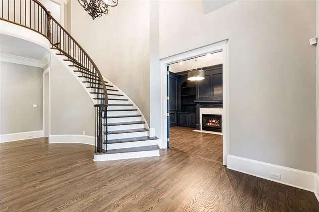 a view of a livingroom with wooden floor and a ceiling fan