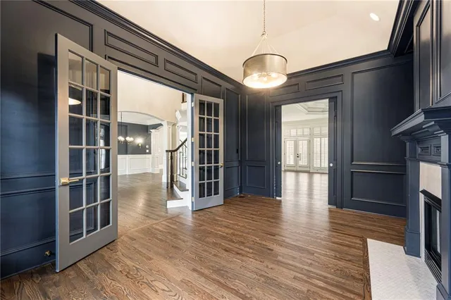 a view of an empty room with a fireplace and a window