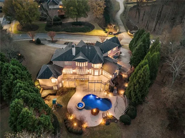 a view of a house with backyard and sitting area