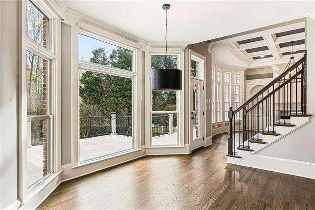 a view of an empty room with cabinet and a window