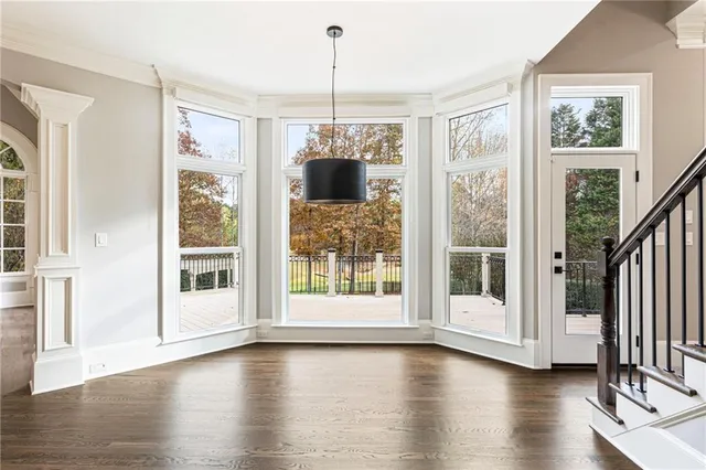 an empty room with windows and closet