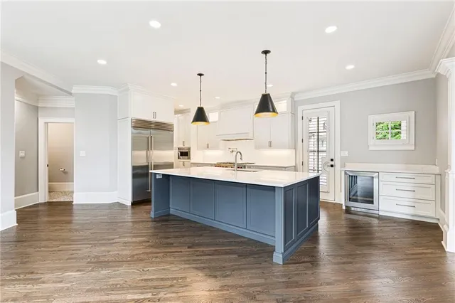 a view of backyard with table and chairs and potted plants