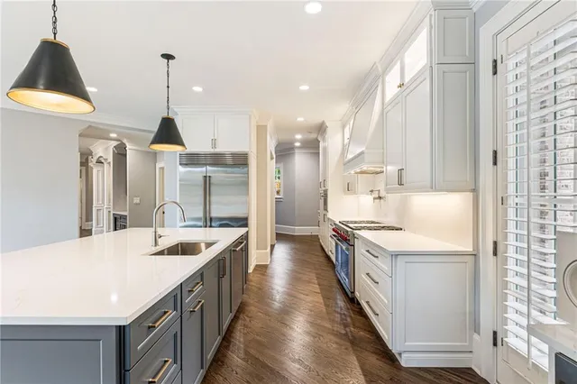 a view of a white house with a swimming pool and wooden fence