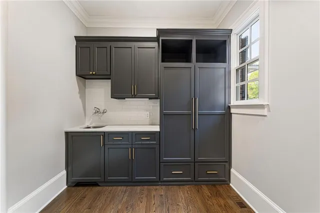 a front view of a house with a garden and yard