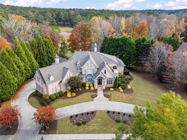 a living room with furniture a fireplace and a table