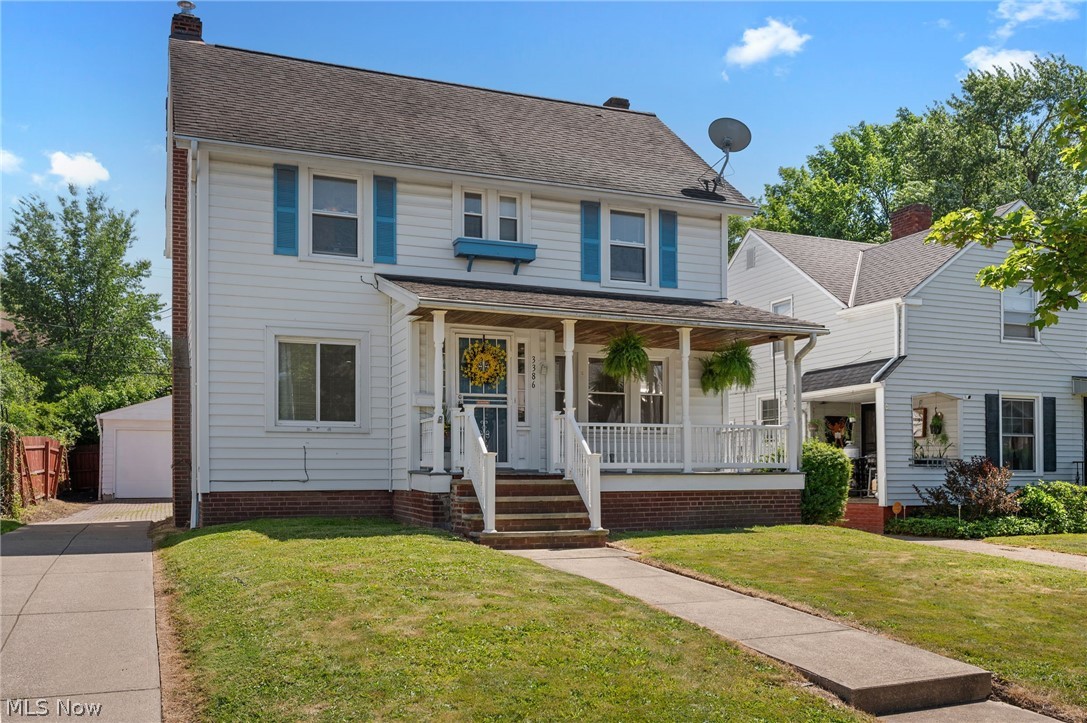 Traditional white siding exterior with a covered front porch featuring white railings