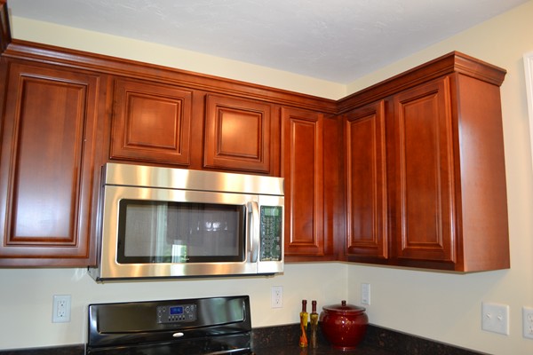 4 Waxen Way Shirley, MA 01464 - Photo 5 of 12 a kitchen with stainless steel appliances granite countertop cabinets and a microwave oven