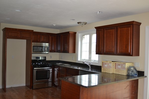 4 Waxen Way Shirley, MA 01464 - Photo 7 of 12 a kitchen with granite countertop a sink and steel appliances