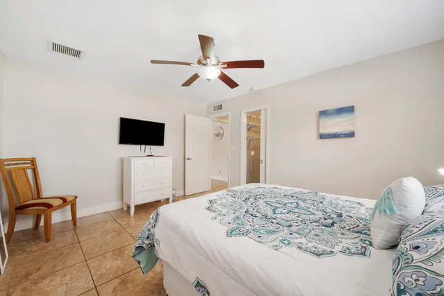 a bedroom with a bed and a chair