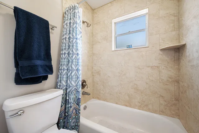 a bathroom with a toilet and a bathtub