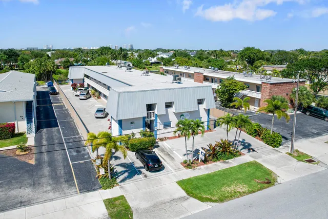 a aerial view of a house with garden space and lake view