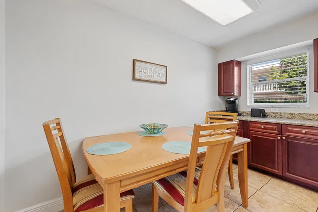 a view of a dining room with furniture and window