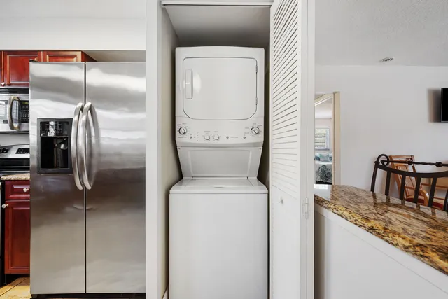 a bathroom with a granite countertop sink a toilet and a mirror