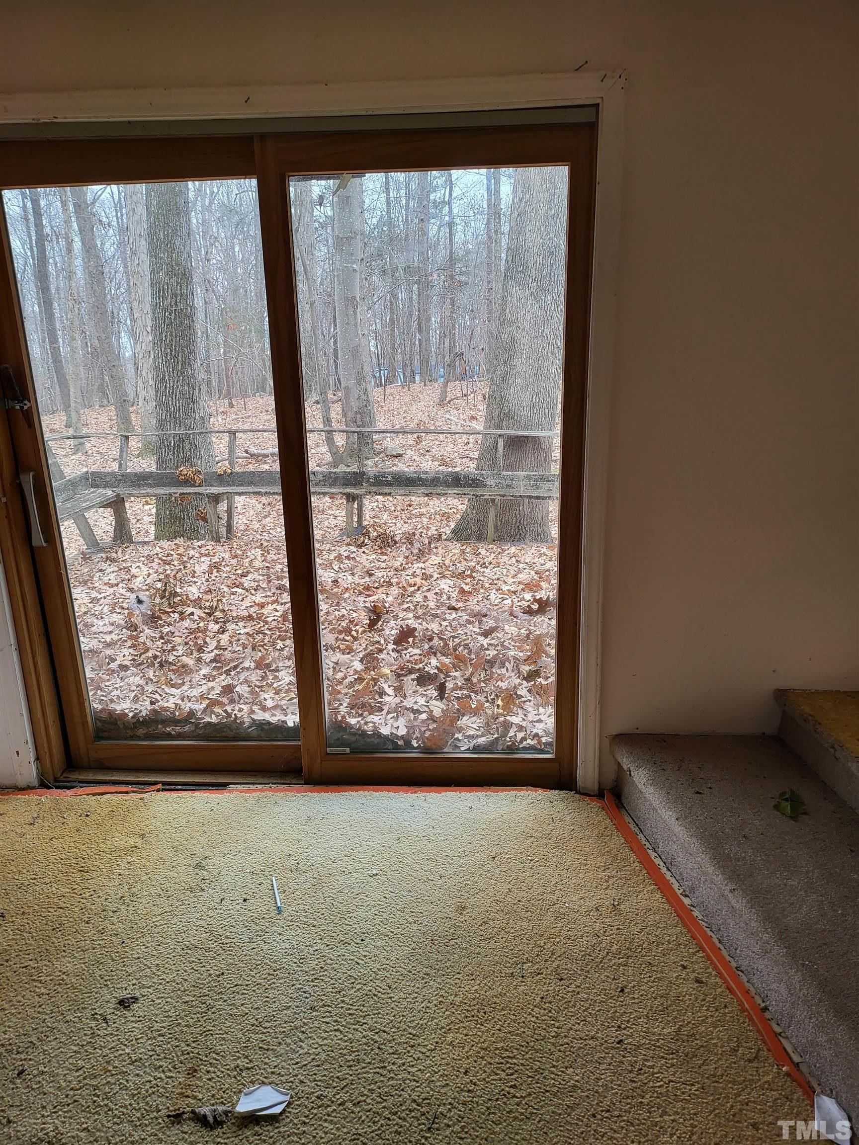 7808 Russell Road Durham, NC 27712 - Photo 6 of 8 a view of room with window and wooden floor