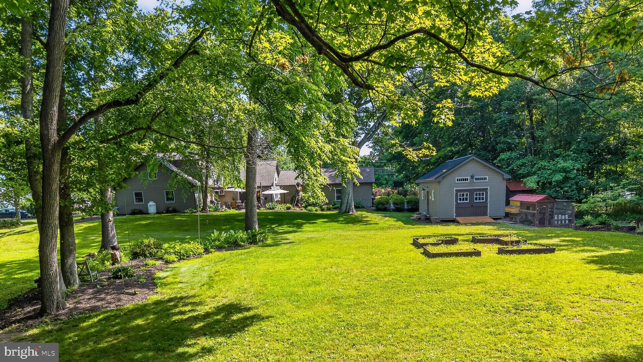 460 Wells Road Doylestown, PA 18901 - Photo 5 of 65 Serene backyard oasis with lush greenery.