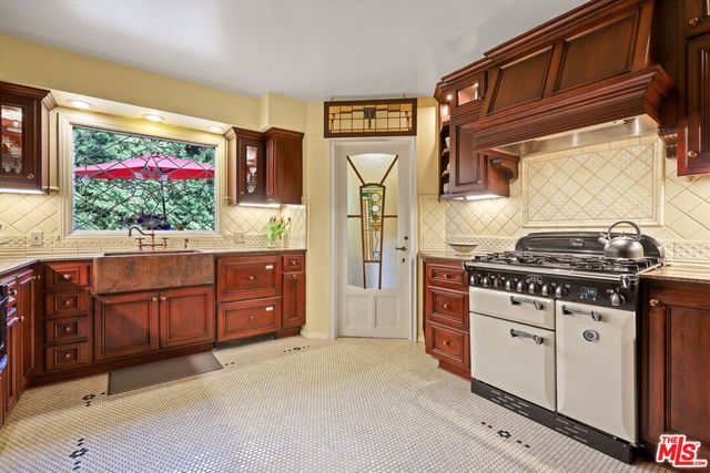a kitchen with stainless steel appliances a stove and a microwave
