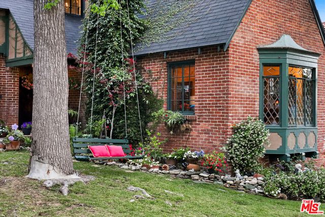 a backyard of a house with lots of green space and fountain view