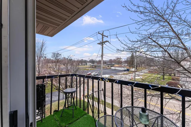 a view of a chairs and table in the balcony
