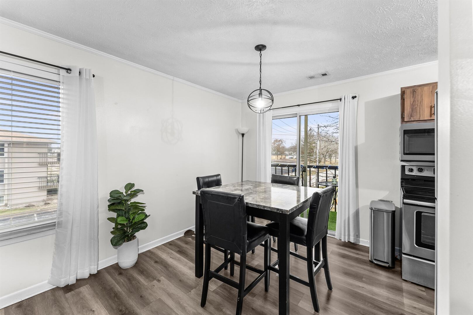 1808 53rd Street, Unit 5 Moline, IL 61265 - Photo 4 of 14 a view of a dining room with furniture window and wooden floor