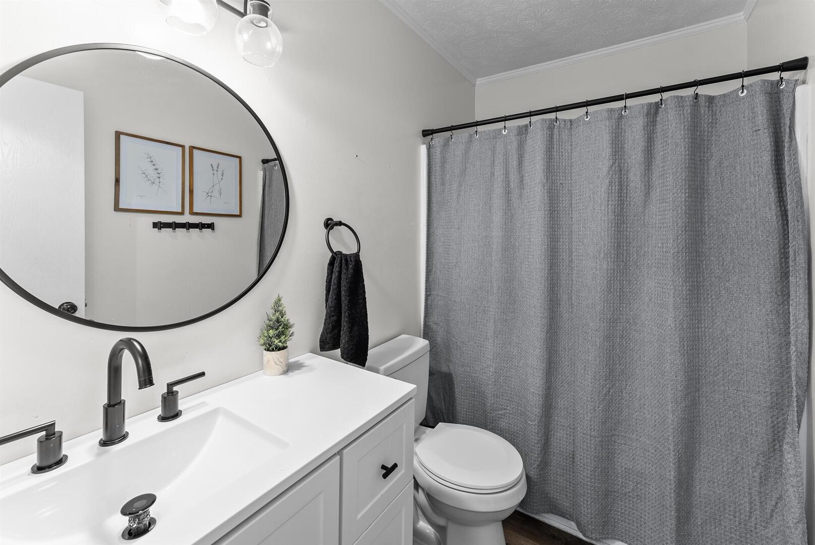 1808 53rd Street, Unit 5 Moline, IL 61265 - Photo 10 of 14 a bathroom with a sink mirror and toilet