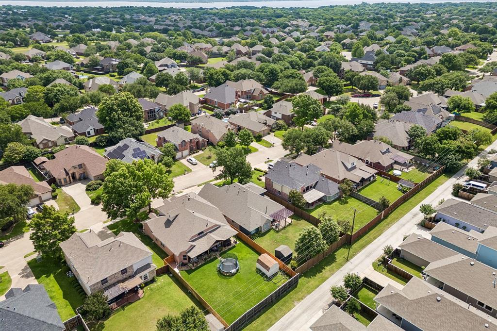 9217 Inverness Drive Rowlett, TX 75089 - Photo 33 of 40 Waterview Community Setting — Surrounded by tree-lined streets and neighborhood rooftops, this home enjoys an established location with Lake Ray Hubbard visible in the distance.
