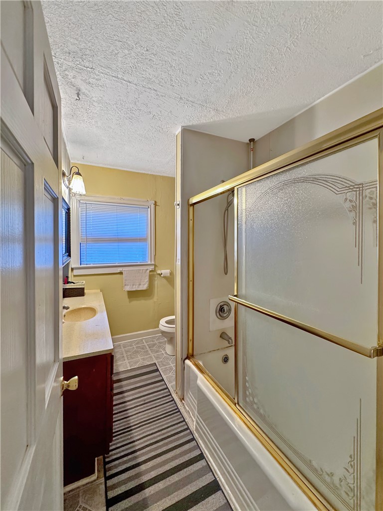 203 Dellwood Street Bryan, TX 77801 - Photo 5 of 9 a bathroom with a shower and a sink