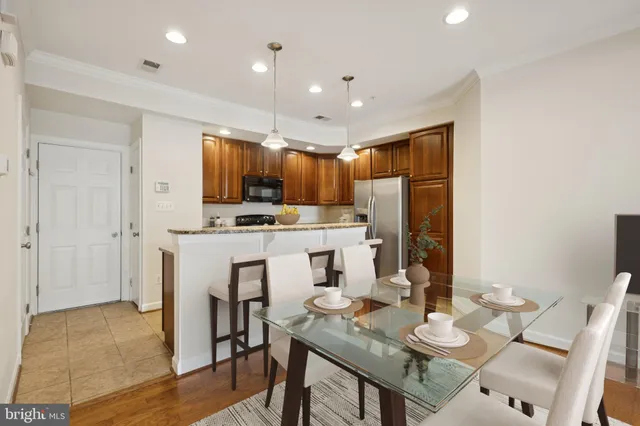 a view of kitchen with stainless steel appliances a refrigerator and a stove top oven