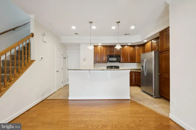 a kitchen with granite countertop stainless steel appliances and wooden cabinets