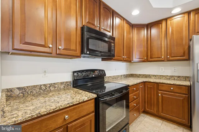 a metallic refrigerator freezer sitting in a kitchen