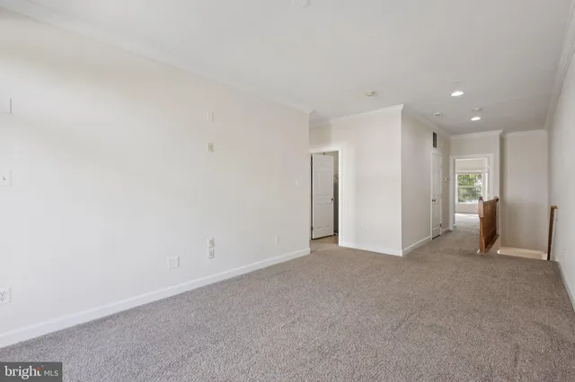 a bedroom with a large bed couch and a window