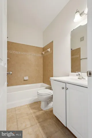 a bathroom with a tub sink shower and mirror