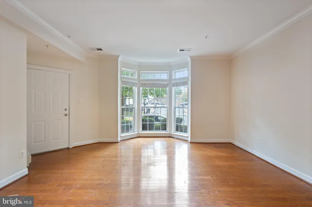 a living room with furniture a flat screen tv and a large window