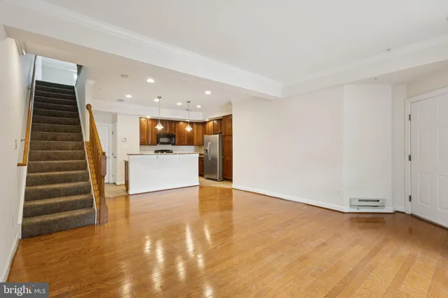 a kitchen with kitchen island granite countertop stainless steel appliances cabinets a dining table and chairs