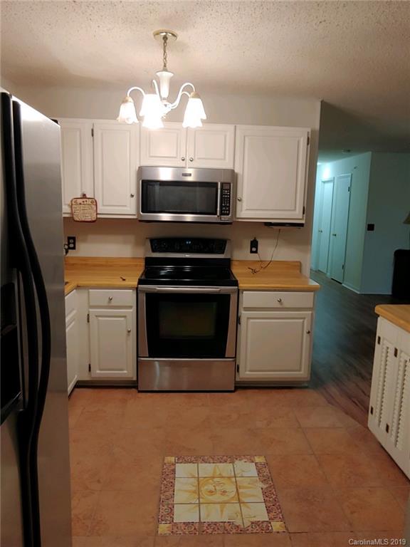 371 Murray Road Canton, NC 28716 - Photo 8 of 25 a kitchen with stainless steel appliances a stove a sink and a refrigerator