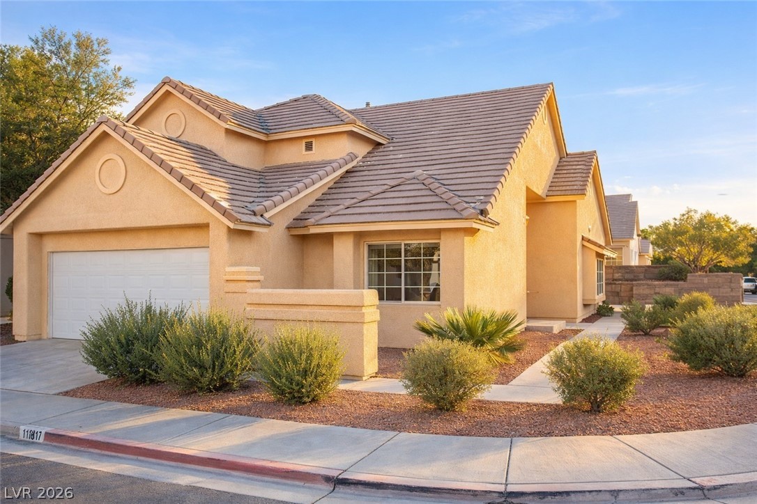 2525 Aberdeen Lane Henderson, NV 89014 - Photo 1 of 1 View of front of house featuring an attached garage, driveway, a tiled roof, and stucco siding