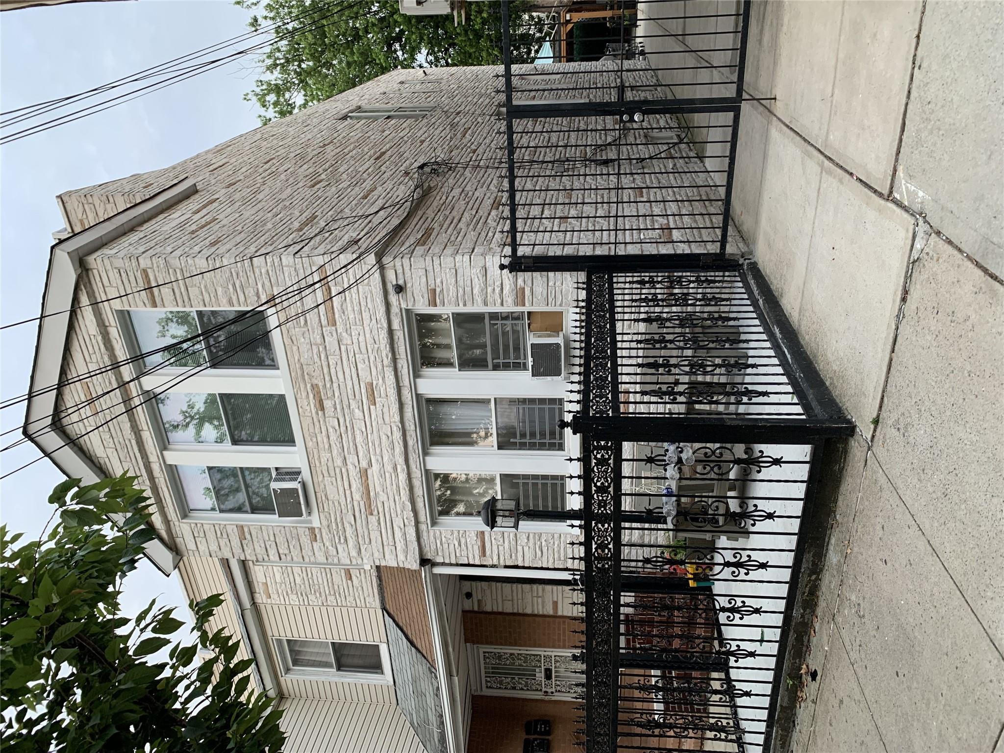 a front view of a house with iron fence