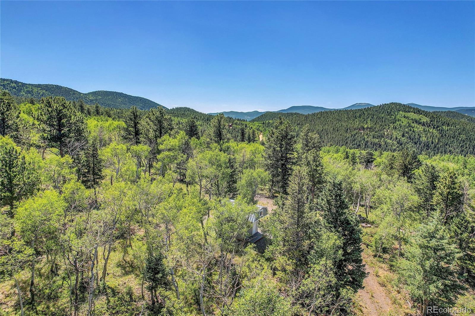 4 Hughesville Road Black Hawk, CO 80422 - Photo 27 of 29 a view of a mountain range with lush green forest