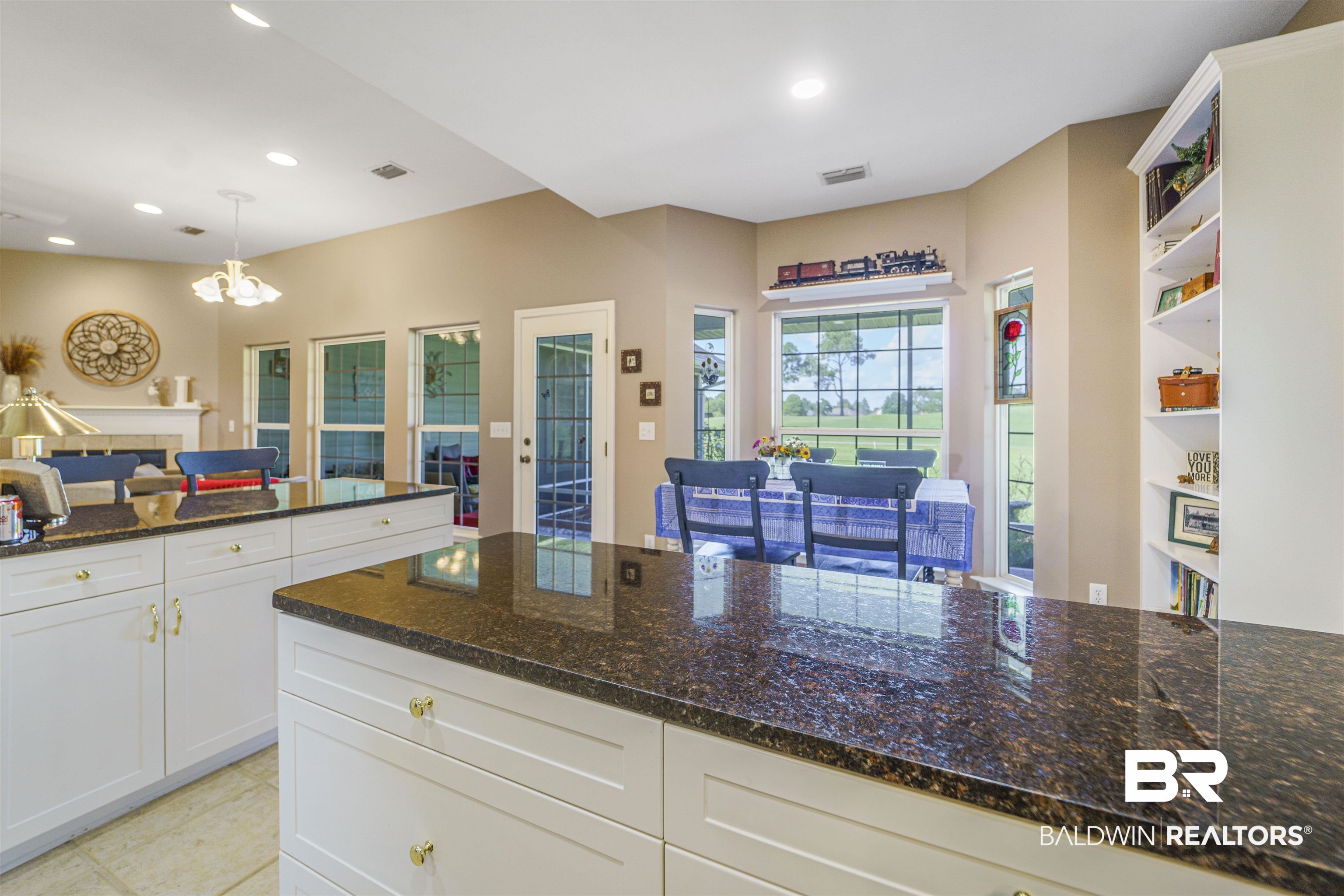 9505 Lakeview Drive Foley, AL 36535 - Photo 13 of 38 Kitchen featuring open shelves, dark stone countertops, hanging light fixtures, recessed lighting, and white cabinets